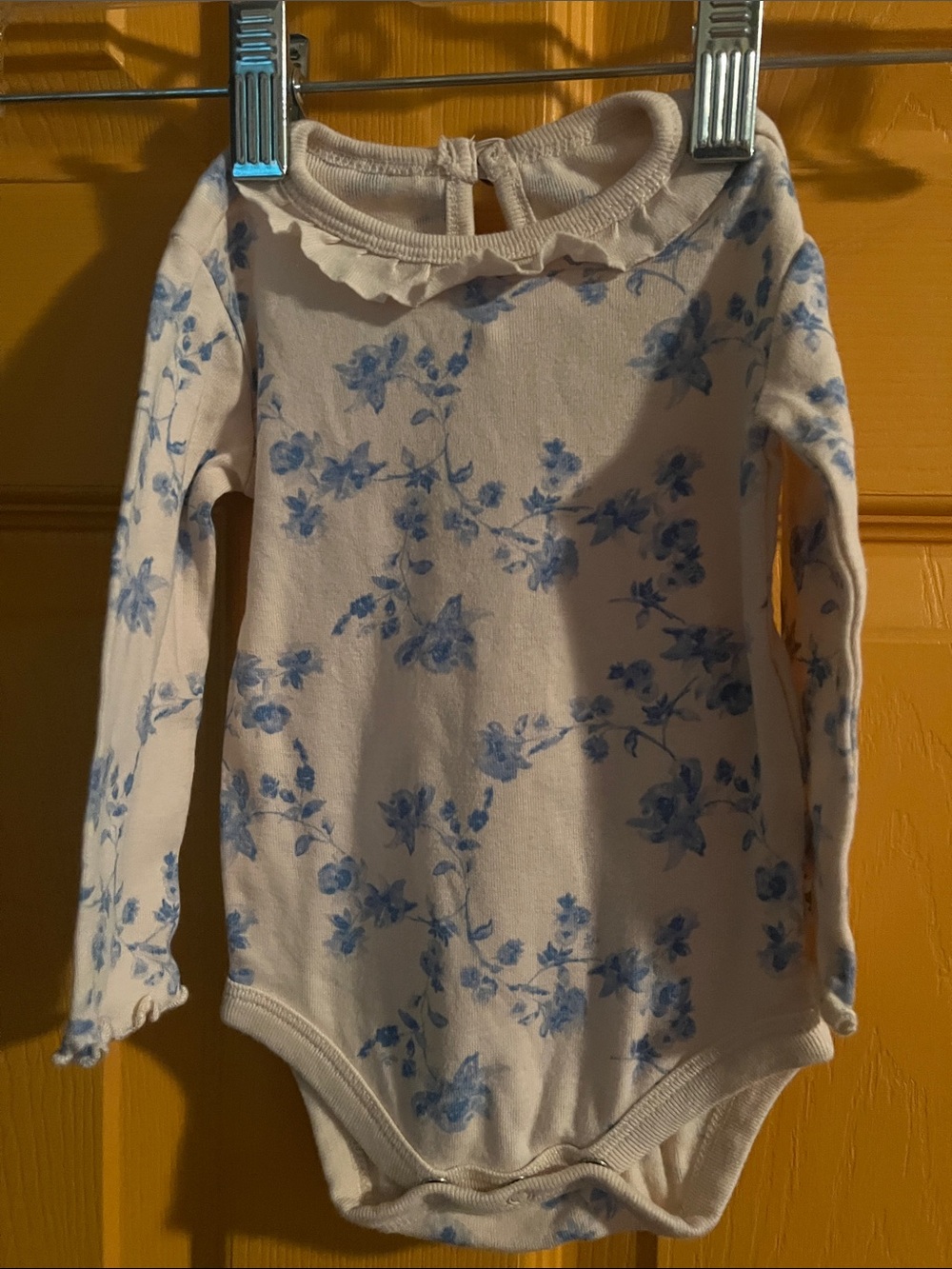 NEWBORN BURT’S BEES CREAM ONE-PIECE ONESIE WITH BLUE FLORAL PRINT
